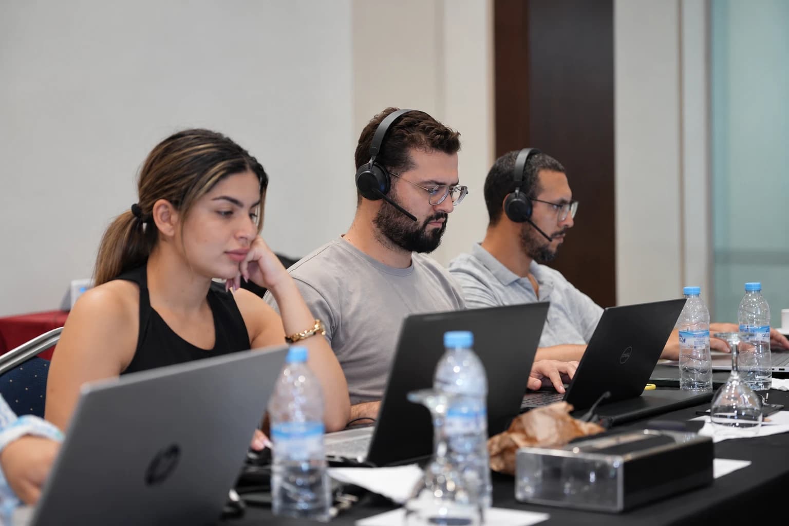 TCrew trainees with headsets working on their laptops during a training session